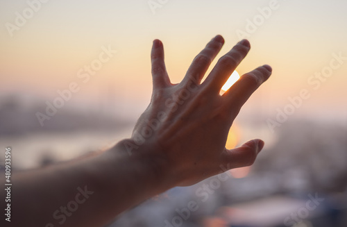 Hand of a man reaching to towards sky.
