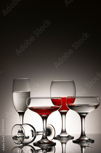 Glassware of different sizes against monochrome background