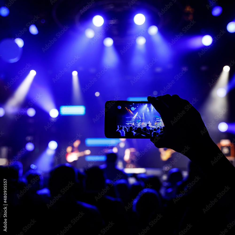 Taking pictures with a smartphone during a concert.