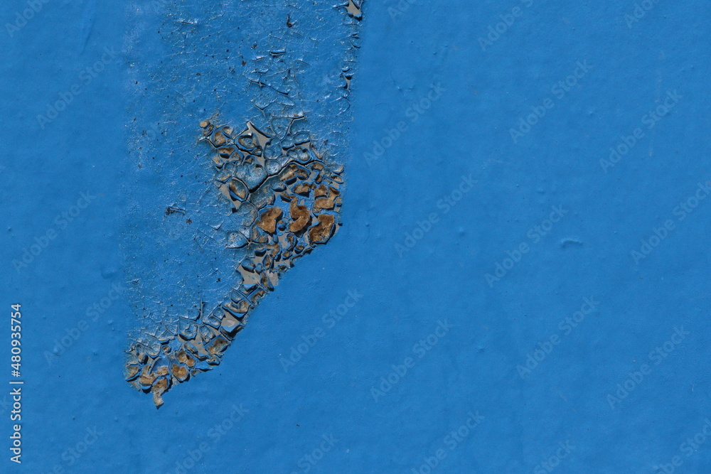 rusting metal door with blue paint, texture background
