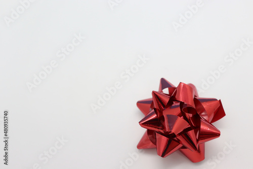 Festive decoration in the form of a red bow on a white background
