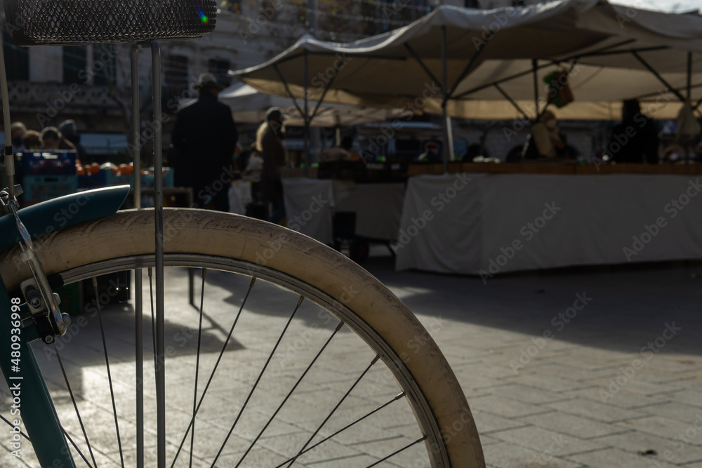 Bicycle wheel parked in a street market