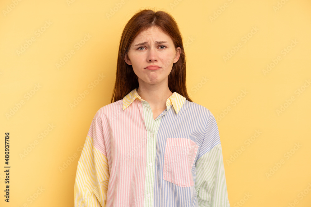 Young English woman isolated on yellow background sad, serious face, feeling miserable and displeased. Young English woman isolated on yellow background sad, serious face, feeling miserable and displeased.
