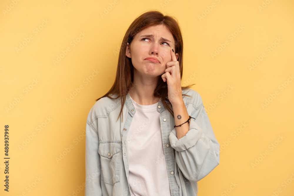 Young English woman isolated on yellow background crying, unhappy with something, agony and confusion concept. Young English woman isolated on yellow background crying, unhappy with something, agony and confusion concept.