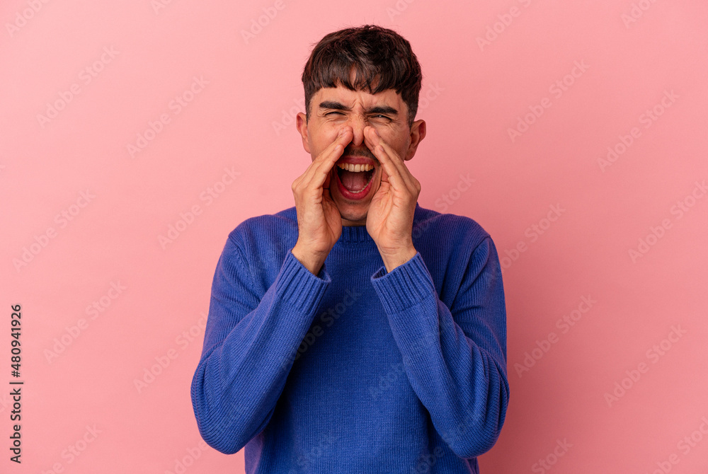 Young mixed race man isolated on pink background shouting excited to front. Young mixed race man isolated on pink background shouting excited to front.