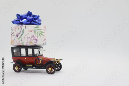 Retro car with a gift on top © SIARHEI BEZPALKA