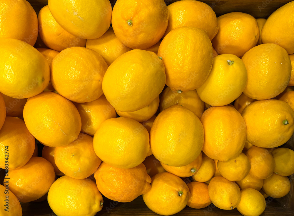 Background of yellow lemons. The texture of lemons. Lemons close-up