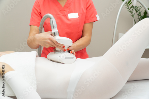 Tapeta Close-up of a woman receiving LPG massage against cellulite on her stomach buttocks and legs
