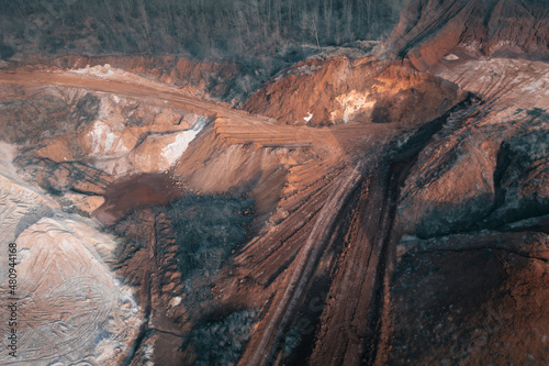 Industrial landscape of quarry: mining of mineral natural resources: clay and sand. Excavated Industrial Clay Quarry: Open-Pit Sand and Clay Mining in Deep Industrial Quarry. Aerial drone shot.