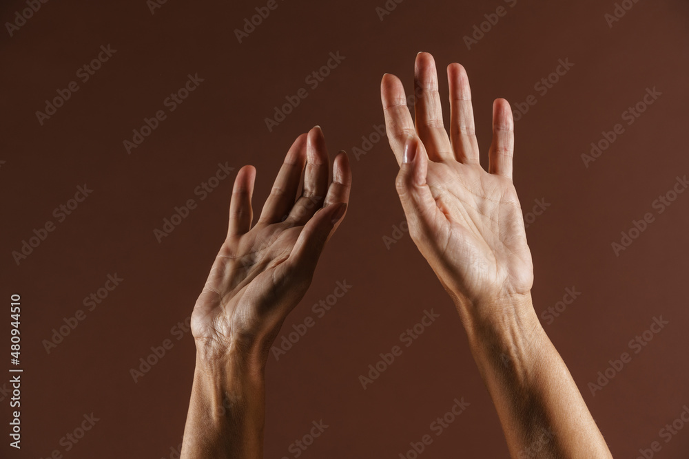 Senior woman gesturing while showing her hands on camera Senior woman gesturing while showing her hands on camera