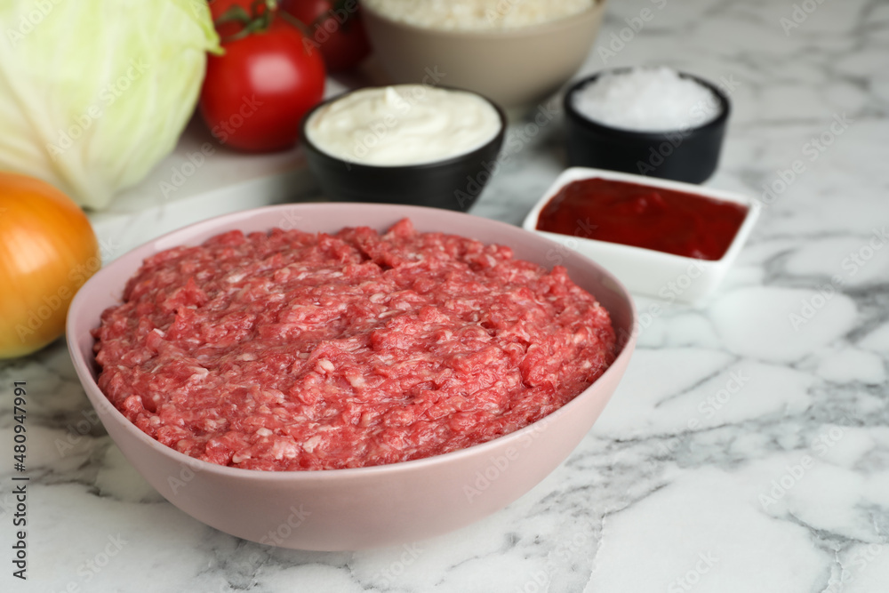 Set of ingredients for preparing stuffed cabbage rolls on white marble table Set of ingredients for preparing stuffed cabbage rolls on white marble table