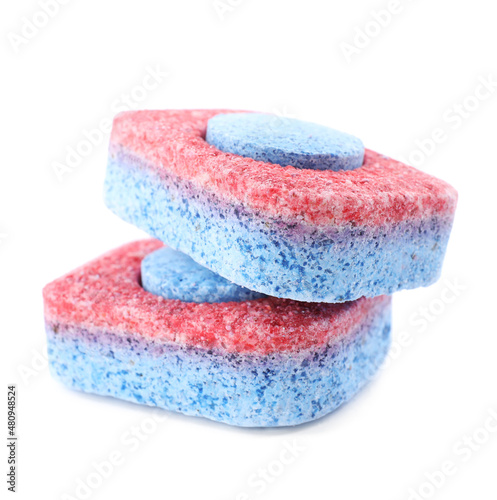 Two dishwasher detergent tablets on white background