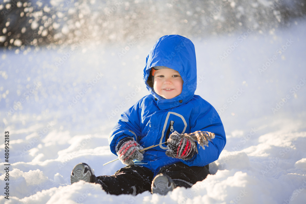 Kid walks in the winter like a little snowman. Cute baby Toddler playing in the snow. Children have fun outside in winter. Kid walks in the winter like a little snowman. Cute baby Toddler playing in the snow. Children have fun outside in winter.