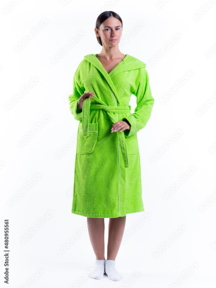 Fototapeta premium woman in a Bathrobe on an isolated white background with a smile on her face.