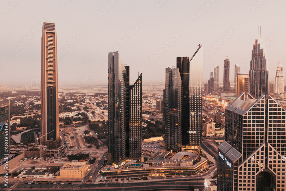 Obraz premium DUBAI, UAE - FEBRUARY 2018: Dubai skyline at sunset with Burj Khalifa, the world tallest building and Sheikh Zayed road traffic