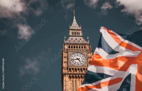 flag of UK waving in front of Big Ben and Westmister Abbey  London  UK