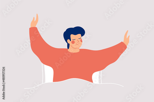 Happy man wakes up and feels good yourself. Smile boy makes morning stretch in the bed. Body positive and health care concept.