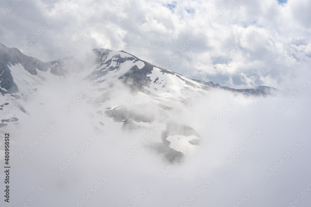 Alpine mountains in Austria. Grosglockner road in fog Alpine mountains in Austria. Grosglockner road in fog