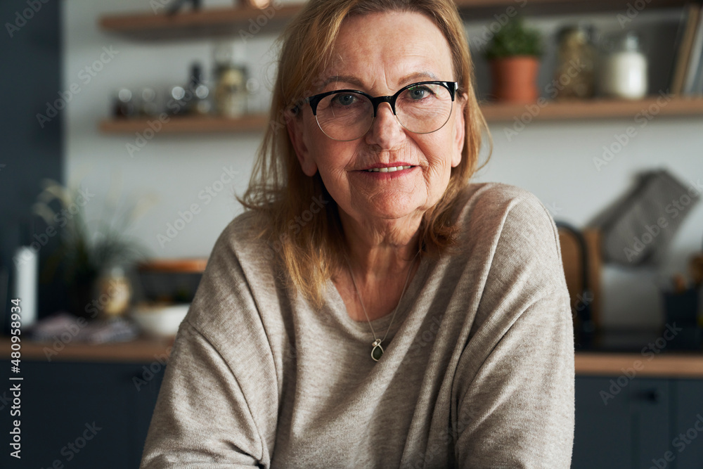 Portrait of caucasian senior woman leaning in the kitchen island Portrait of caucasian senior woman leaning in the kitchen island