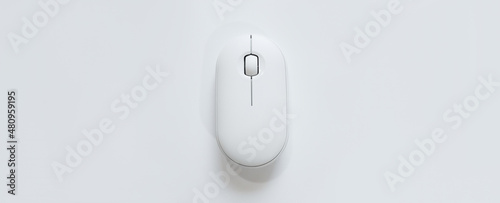 Computer white mouse in hand on a white background in banner format. Computer equipment and accessories