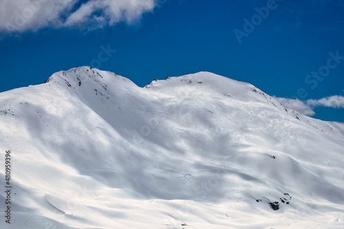 Embrace the Breathtaking Beauty of a Snowy Mountain Top in the Majestic French Alps, Under a Crystal Blue Sky
