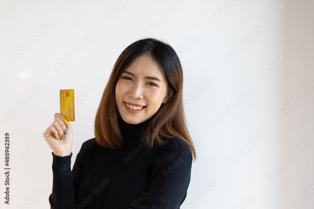 Cheerful smiling Asian woman holding credit card happy. Cheerful smiling Asian woman holding credit card happy.