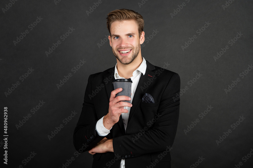 happy handsome young man in suit with takeaway coffee happy handsome young man in suit with takeaway coffee