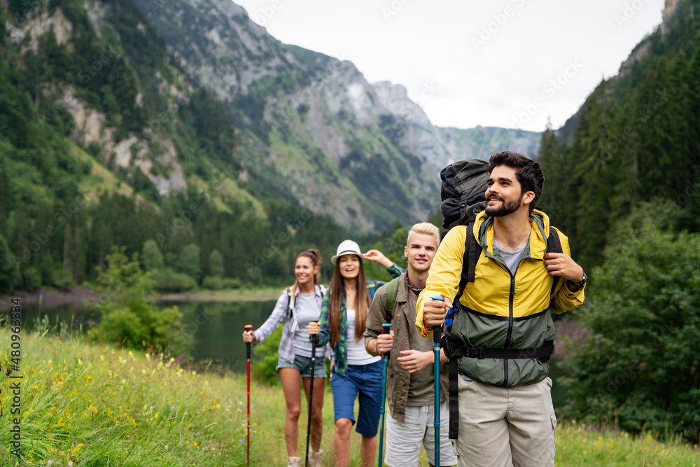 Group of happy hiker friends trekking as part of healthy lifestyle outdoors activity - obrazy, fototapety, plakaty 