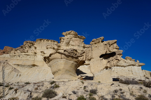 view of the famous sandstone erosions and hoodoos in Bolnuevo under a clear blue sky