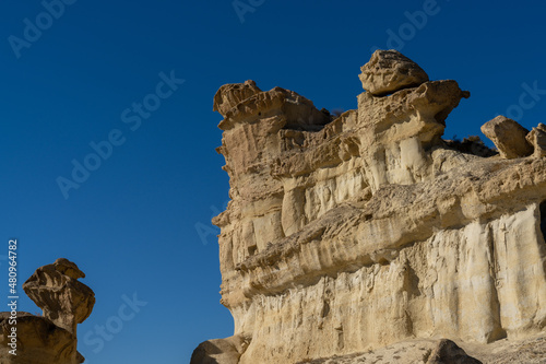 view of the famous sandstone erosions and hoodoos in Bolnuevo under a clear blue sky photo