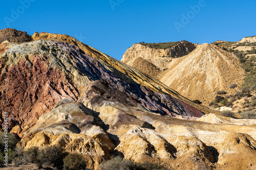 landscape view of colorful earthen hillside in an abandonend mine