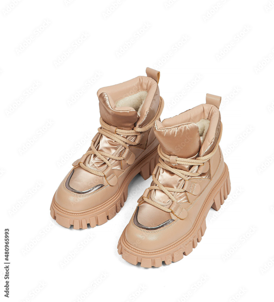 Woman's beige leather warm winter boots over white background Woman's beige leather warm winter boots over white background
