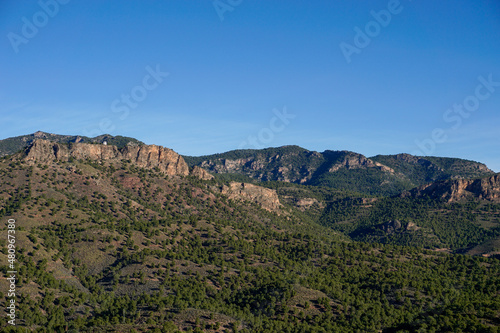 landscape view of Spanish semi-desert with low green vegetation and mountains