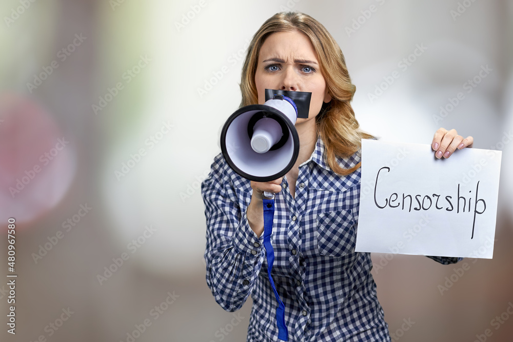 Fototapeta premium Censored woman unable to speak standing against blurred bokeh background.
