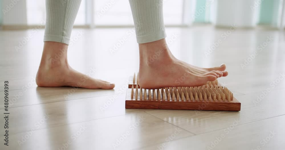 women feet on a sadhu board doing relaxation exercise,close-up. Yoga. Meditation women feet on a sadhu board doing relaxation exercise,close-up. Yoga. Meditation