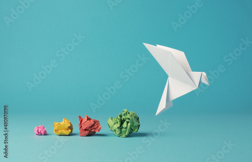 Leinwand Poster Colorful crumpled paper balls with a paper dove, peace, freedom or opportunities