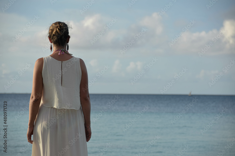Woman looking at the horizon in the Maldives Woman looking at the horizon in the Maldives