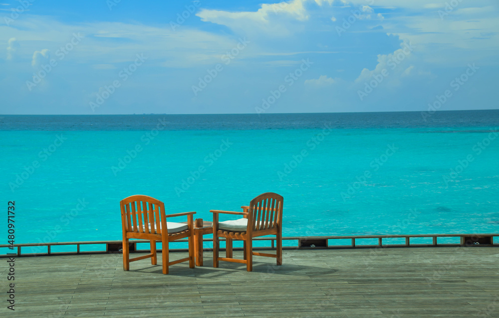 Blue seascape with 2 chairs