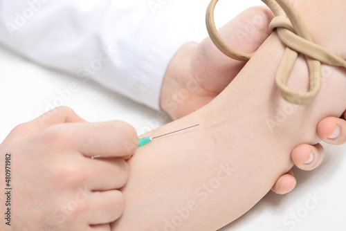 Hands of doctor inject a patient into vein. How to give an intravenous injection concept. Close-up