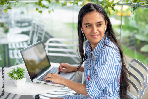 Young woman working outdoors with laptop