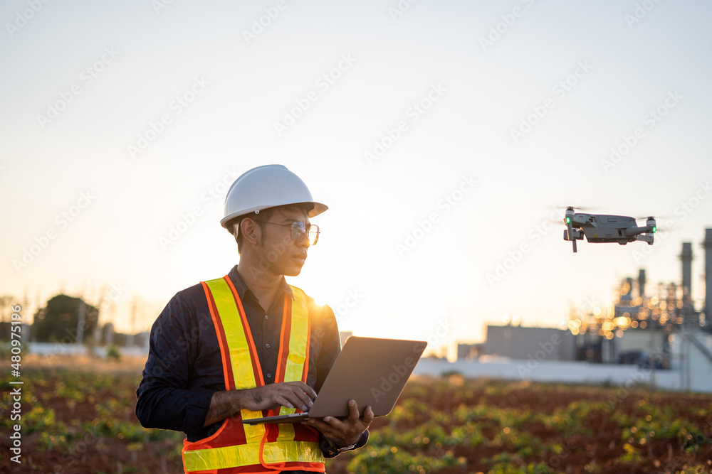 Engineers are using laptop control drones to perform aerial inspections at work. Useful technology in work Engineers are using laptop control drones to perform aerial inspections at work. Useful technology in work