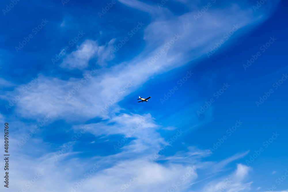 Blue clouds with clouds and a small private plane. Air Transport. Aeroclub. Traveling by air. Hobby flying. Airspace. Means of transport. Between the clouds.