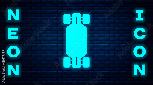 Glowing neon Longboard or skateboard cruiser icon isolated on brick wall background. Extreme sport. Sport equipment. Vector