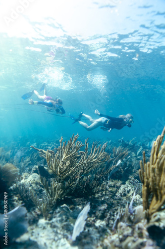 young girl doing snorkeling in crystal clear water