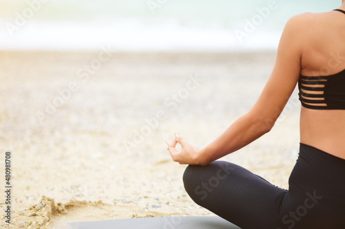 No face portrait of young woman doing yoga or meditating on the seaside. Yoga sport. Healthy wellness lifestyle. Spiritual health. Personal fulfillment.