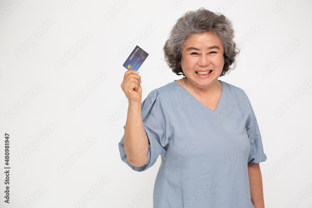 Senior asian woman holding credit card and showing on hand isolated on white background Senior asian woman holding credit card and showing on hand isolated on white background