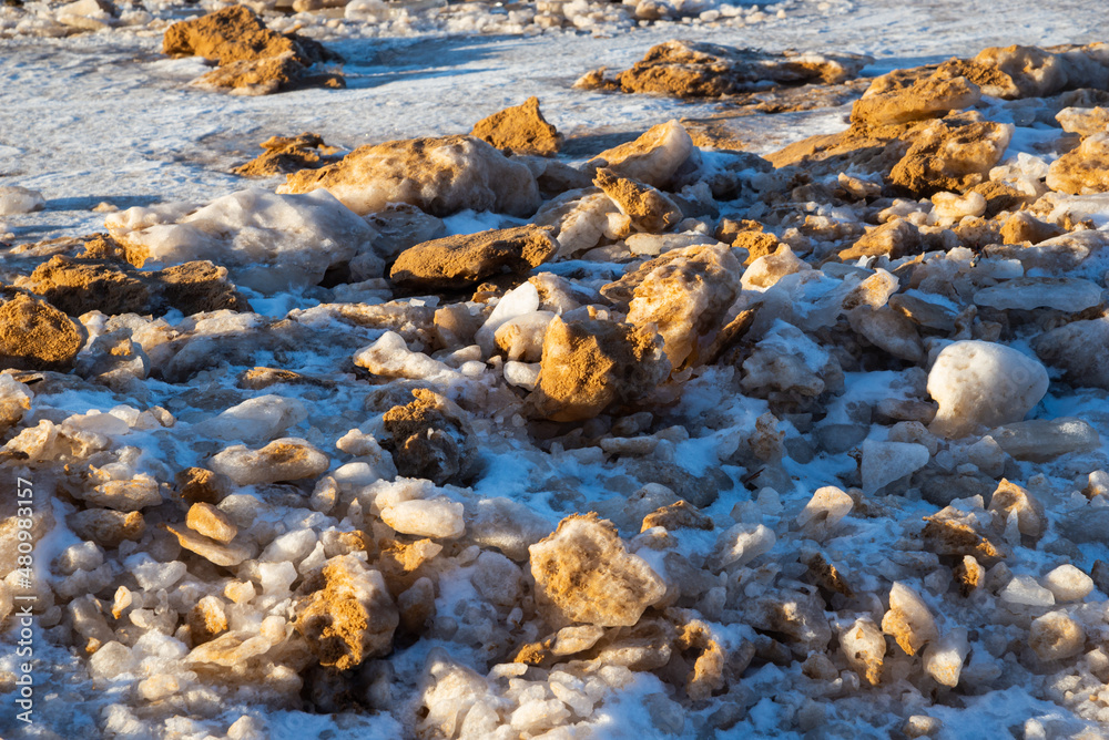 Baltic Sea on wintertime with broken ice cracks. Large pieces of floating ice driven into the seaside. Pack Ice builds up the icebergs.