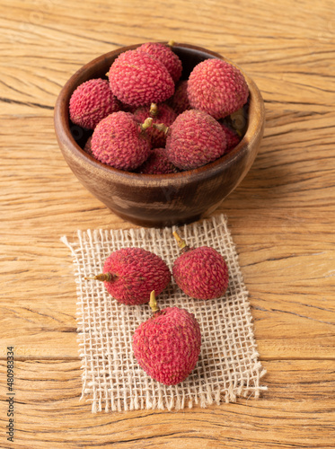 Lychees in a bowl over wooden table