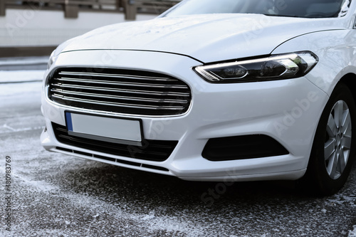 Modern white car outdoors on snowy day, closeup