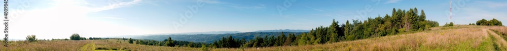 Panorama of the landscape with transmission towers and mountains in the background